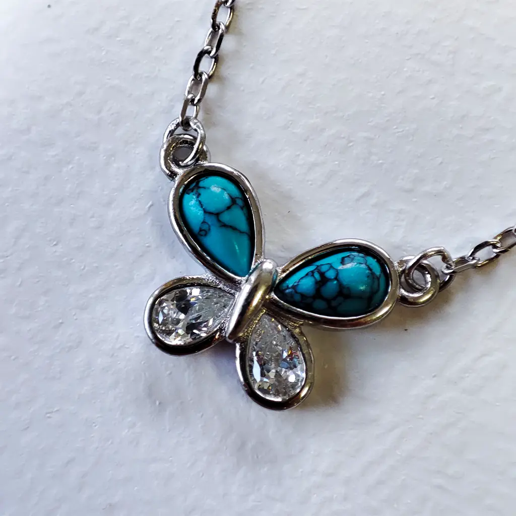 Colgante mariposa con piedras turquesa en plata de ley