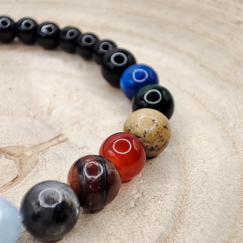 Pulsera Armonía Cósmica de Minerales Planetarios 6 mm Pulsera de minerales planetarios de 6 mm inspirada en las energías del sistema solar para armonía y equilibrio energético.