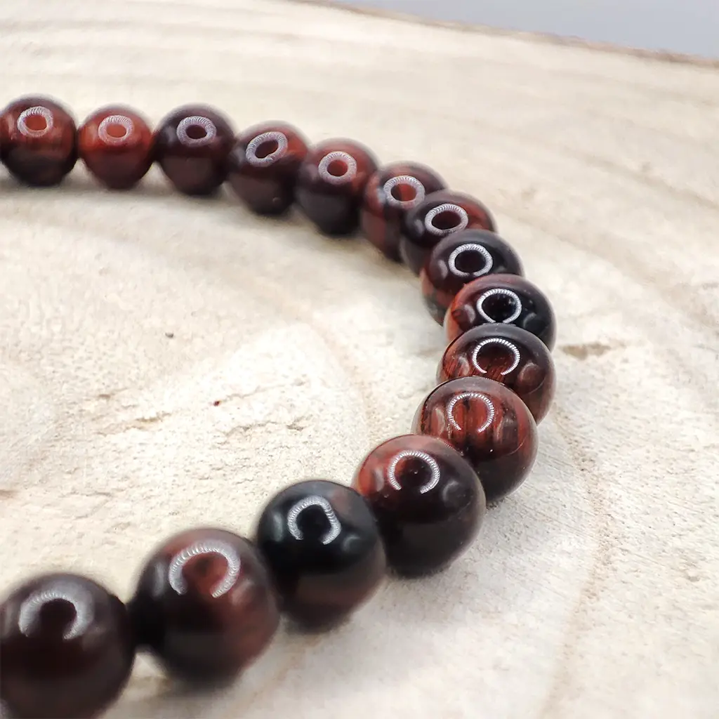 Pulsera de Ojo de Buey natural de 6 mm en tonos rojizos y marrones.