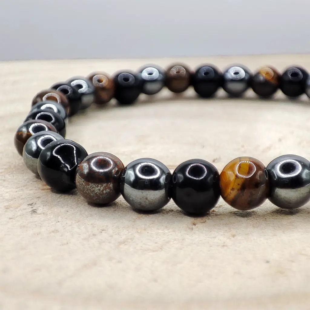 Pulsera Triple Protección de Ojo de Tigre, Obsidiana y Hematita 6 mm Pulsera de Ojo de Tigre, Obsidiana y Hematita natural de 6 mm para protección energética y equilibrio emocional.