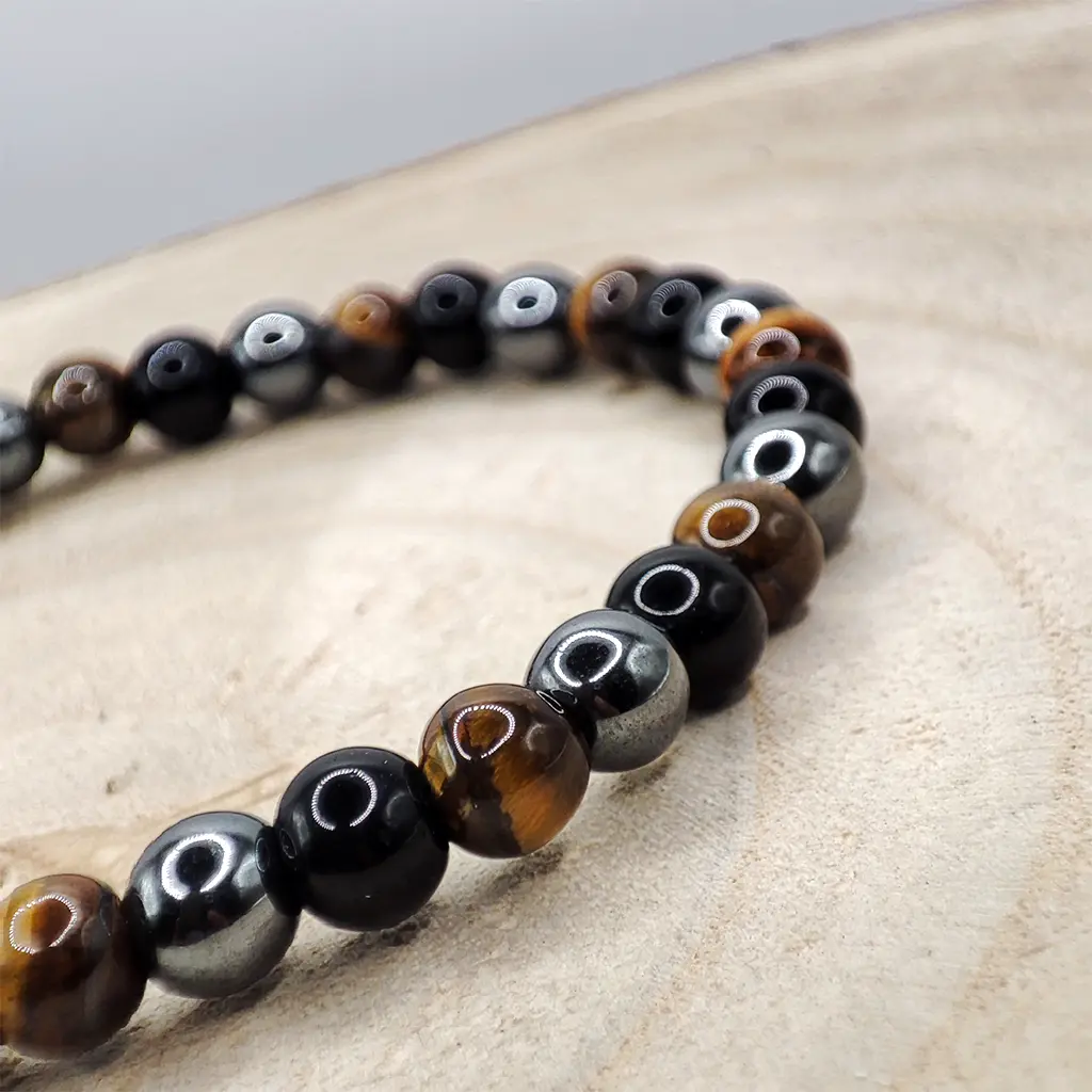 Pulsera Triple Protección de Ojo de Tigre, Obsidiana y Hematita 6 mm Pulsera de Ojo de Tigre, Obsidiana y Hematita natural de 6 mm para protección energética y equilibrio emocional.