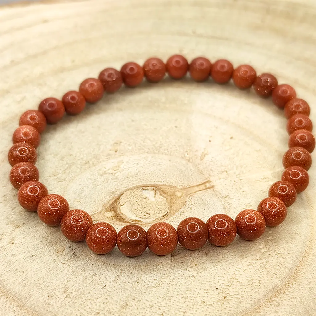 Pulsera de Venturina Dorada natural de 6 mm con reflejos brillantes.